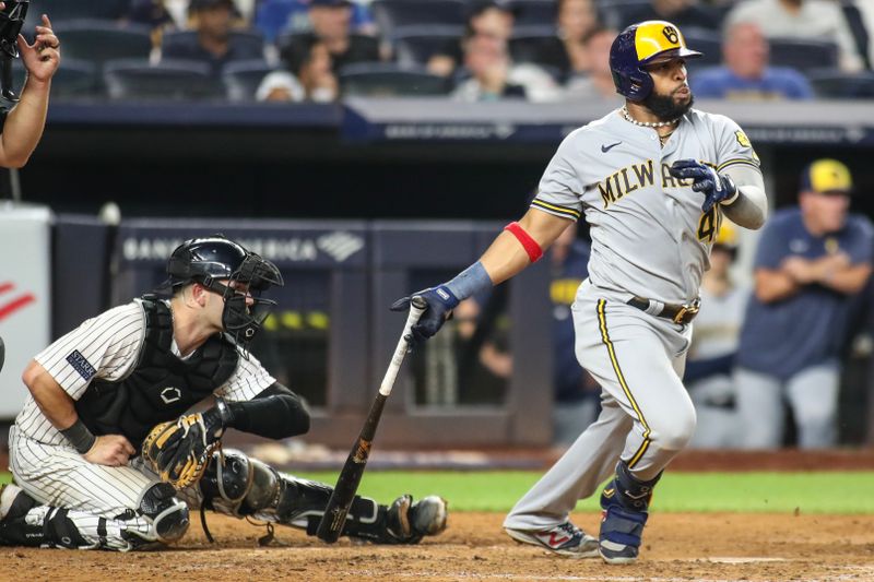 Sep 8, 2023; Bronx, New York, USA;  Milwaukee Brewers first baseman Carlos Santana (41) hits an RBI single in the seventh inning against the New York Yankees at Yankee Stadium. Mandatory Credit: Wendell Cruz-USA TODAY Sports