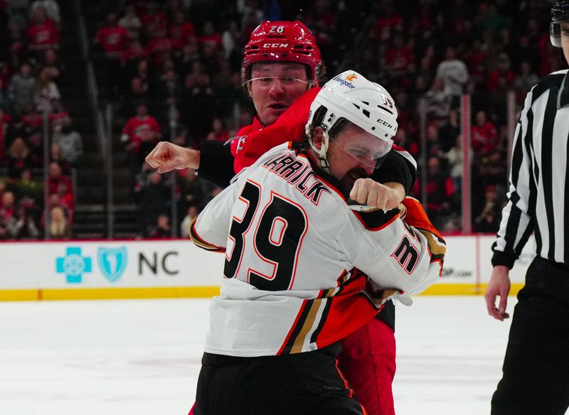 Jan 11, 2024; Raleigh, North Carolina, USA; Carolina Hurricanes left wing Brendan Lemieux (28) and Anaheim Ducks center Sam Carrick (39) fight during the second period at PNC Arena. Mandatory Credit: James Guillory-USA TODAY Sports