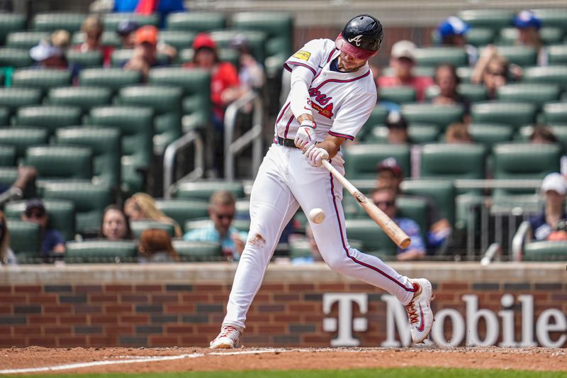 Apr 23, 2025; Cumberland, Georgia, USA; Atlanta Braves first base Matt Olson (28) singles against the St. Louis Cardinals during the eighth inning at Truist Park. Mandatory Credit: Dale Zanine-Imagn Images