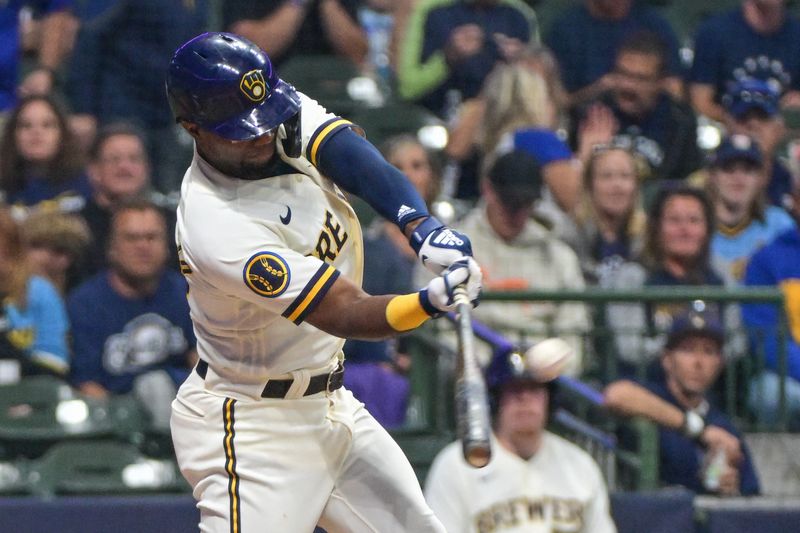 Sep 12, 2023; Milwaukee, Wisconsin, USA; Milwaukee Brewers third baseman Andruw Monasterio (14) hits a double in the seventh inning against the Miami Marlins at American Family Field. Mandatory Credit: Benny Sieu-USA TODAY Sports