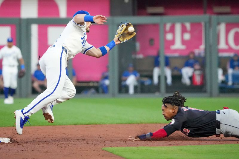 Sep 4, 2024; Kansas City, Missouri, USA; Kansas City Royals shortstop Bobby Witt Jr. (7) takes the throw from catcher Freddy Fermin (34) (not pictured) and tags out Cleveland Guardians third baseman José Ramírez (11) trying to steal second base in the third inning at Kauffman Stadium. Mandatory Credit: Denny Medley-Imagn Images