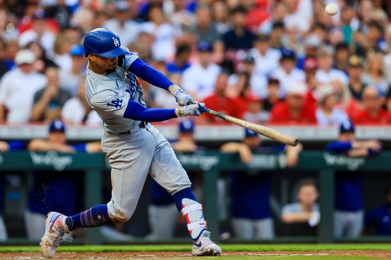 May 24, 2024; Cincinnati, Ohio, USA; Los Angeles Dodgers shortstop Mookie Betts (50) hits a RBI double against the Cincinnati Reds in the second inning at Great American Ball Park. Mandatory Credit: Katie Stratman-USA TODAY Sports