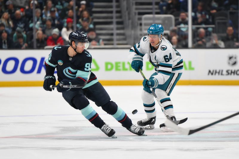 Nov 30, 2024; Seattle, Washington, USA; San Jose Sharks center Mikael Granlund (64) passes the puck past Seattle Kraken left wing Andre Burakovsky (95) during the first period at Climate Pledge Arena. Mandatory Credit: Steven Bisig-Imagn Images