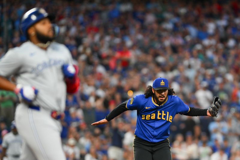 Jul 5, 2024; Seattle, Washington, USA; Seattle Mariners relief pitcher Andres Munoz (75) celebrates the force out on Toronto Blue Jays designated hitter Vladimir Guerrero Jr. (27) to end the game during the ninth inning at T-Mobile Park. Mandatory Credit: Steven Bisig-USA TODAY Sports