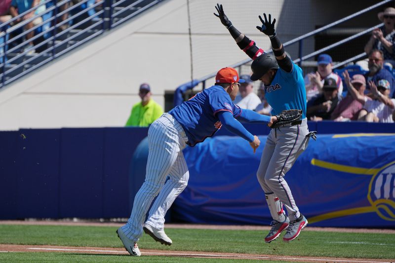 Feb 27, 2024; Port St. Lucie, Florida, USA;  New York Mets first baseman Ji-Man Choi (26) tags out Miami Marlins second baseman Luis Arraez (3) in the first inning at Clover Park. Mandatory Credit: Jim Rassol-USA TODAY Sports