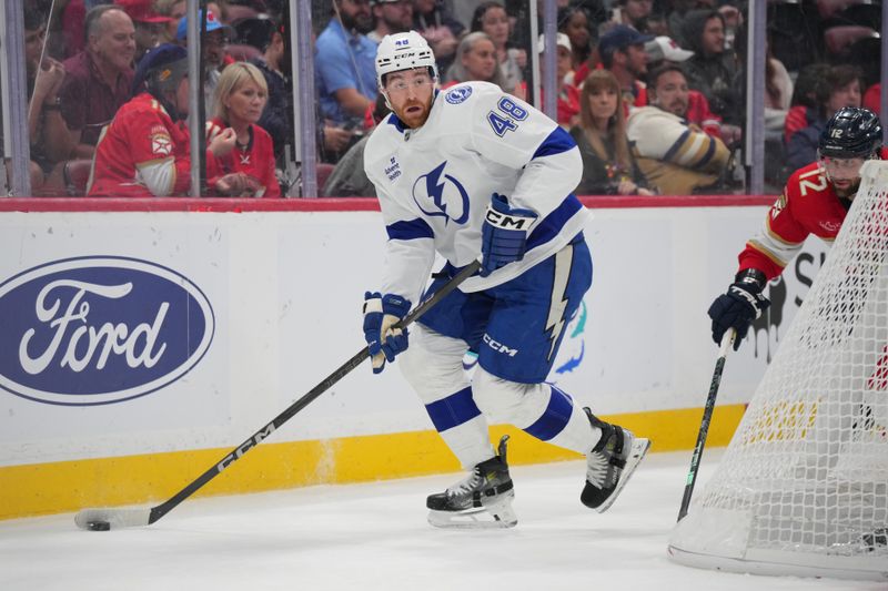 Sep 30, 2024; Sunrise, Florida, USA; Tampa Bay Lightning defenseman Nick Perbix (48) brings the puck out from behind the net against the Florida Panthers during the second period at Amerant Bank Arena. Mandatory Credit: Jim Rassol-Imagn Images