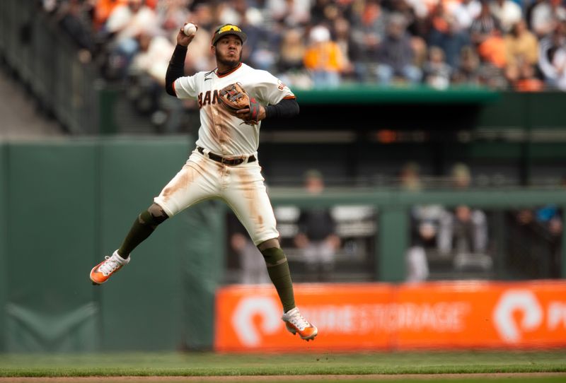 May 20, 2023; San Francisco, California, USA; San Francisco Giants second baseman Thairo Estrada (39) leaves his feet to throw out Miami Marlins left fielder Bryan De La Cruz at first base during the seventh inning at Oracle Park. Mandatory Credit: D. Ross Cameron-USA TODAY Sports