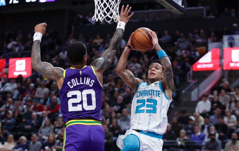 SALT LAKE CITY, UT - FEBRUARY 22:  Tre Mann #23 of the Charlotte Hornets drives to the basket against John Collins #20 of the Utah Jazz during the second half of their game at the Delta Center on February 22, 2024 in Salt Lake City, Utah.  NOTE TO USER: User expressly acknowledges and agrees that, by downloading and or using this Photograph, User is concenting to the terms and conditions of the Getty Images license Agreement. (Photo by Chris Gardner/Getty Images)