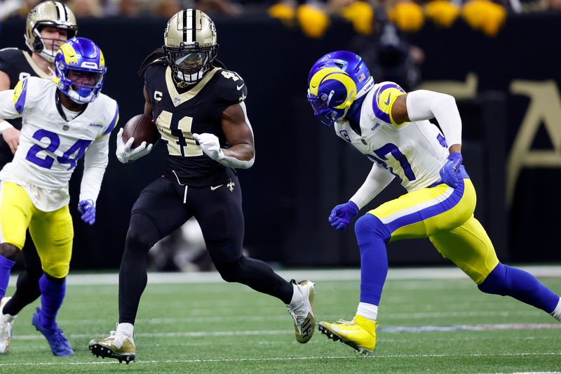 New Orleans Saints running back Alvin Kamara (41) runs the ball past Los Angeles Rams cornerback A.J. Green III (27) during an NFL football game, Sunday, Dec. 1, 2024, in New Orleans. (AP Photo/Tyler Kaufman)