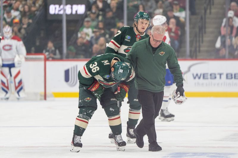 Nov 14, 2024; Saint Paul, Minnesota, USA; Minnesota Wild right wing Mats Zuccarello (36) is escorted off the ice by the trainer in the first period against the Montreal Canadiens at Xcel Energy Center. Mandatory Credit: Matt Blewett-Imagn Images