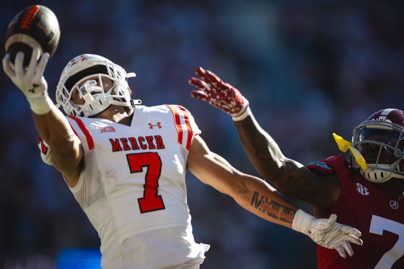 Nov 16, 2024; Tuscaloosa, Alabama, USA; Mercer Bears wide receiver Kendall Harris (7) completes a touchdown pass against Alabama Crimson Tide defensive back DaShawn Jones (7) during the second quarter at Bryant-Denny Stadium. Mandatory Credit: Will McLelland-Imagn Images