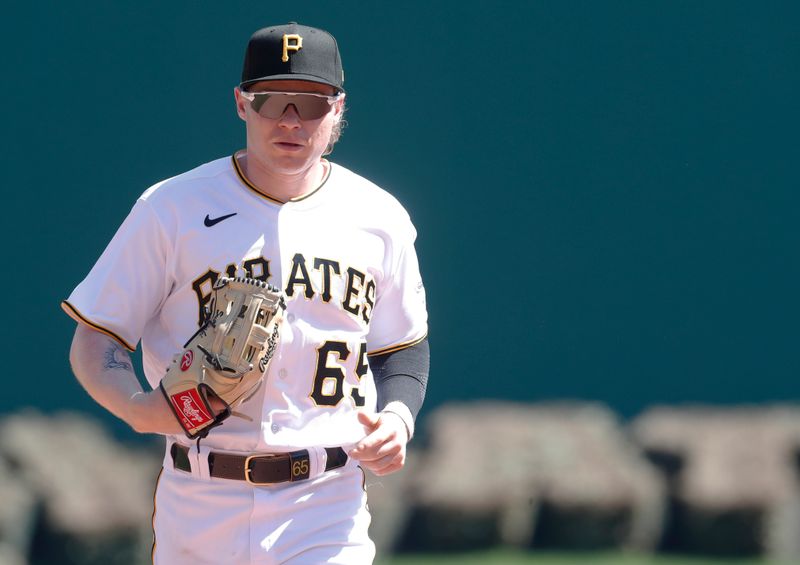 Apr 12, 2023; Pittsburgh, Pennsylvania, USA;  Pittsburgh Pirates center fielder Jack Suwinski (65) jogs off of the field against the Houston Astros after the seventh inning at PNC Park. Mandatory Credit: Charles LeClaire-USA TODAY Sports