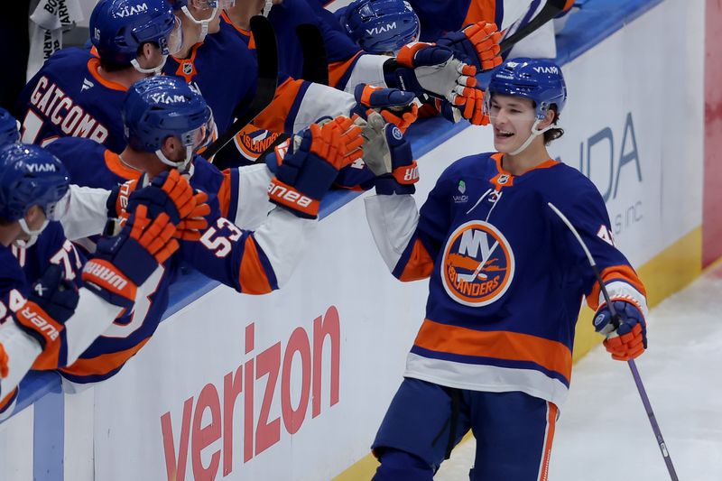 Oct 11, 2025; Elmont, New York, USA; New York Islanders defenseman Matthew Schaefer (48) celebrates his goal against the Washington Capitals with teammates during the third period at UBS Arena. The goal was the first of his NHL career. Mandatory Credit: Brad Penner-Imagn Images