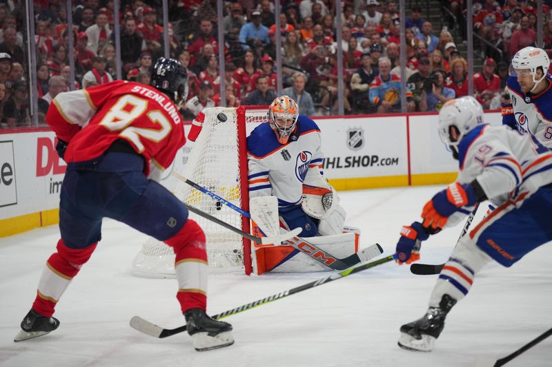 Jun 24, 2024; Sunrise, Florida, USA; Florida Panthers forward Kevin Stenlund (82) shoots the puck against Edmonton Oilers goaltender Skinner Stuart (74) during the second period in game seven of the 2024 Stanley Cup Final at Amerant Bank Arena. Mandatory Credit: Jim Rassol-USA TODAY Sports