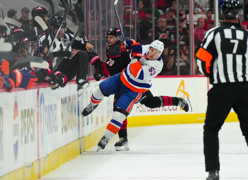 Apr 20, 2024; Raleigh, North Carolina, USA; New York Islanders center Casey Cizikas (53) checks Carolina Hurricanes center Sebastian Aho (20) during the first period in game one of the first round of the 2024 Stanley Cup Playoffs at PNC Arena. Mandatory Credit: James Guillory-USA TODAY Sports