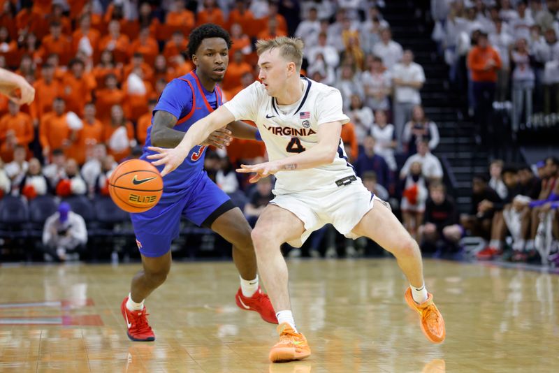 Jan 15, 2025; Charlottesville, Virginia, USA; Virginia Cavaliers guard Andrew Rohde (4) passes the ball around Southern Methodist Mustangs guard Chuck Harris (3) during the second half at John Paul Jones Arena. Mandatory Credit: Amber Searls-Imagn Images