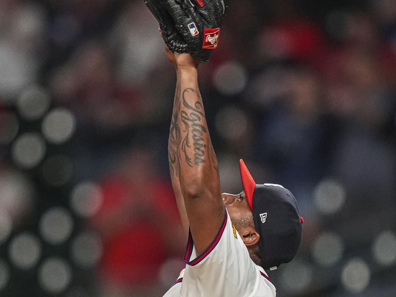 Sep 4, 2024; Cumberland, Georgia, USA; Atlanta Braves pitcher Raisel Iglesias (26) reacts after the Braves defeated the Colorado Rockies at Truist Park. Mandatory Credit: Dale Zanine-Imagn Images
