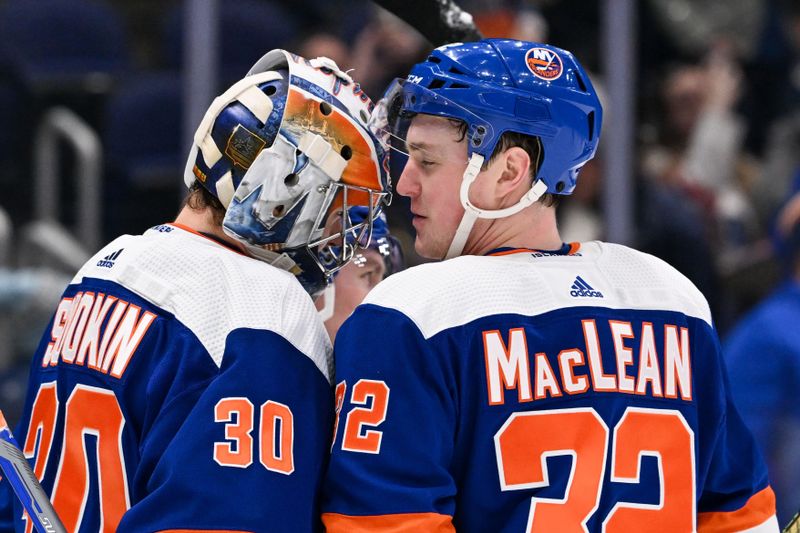 Mar 5, 2024; Elmont, New York, USA; New York Islanders center Kyle MacLean (32) celebrates goaltender Ilya Sorokin (30) after the 4-2 victory against the St. Louis Blues at UBS Arena. Mandatory Credit: Dennis Schneidler-USA TODAY Sports