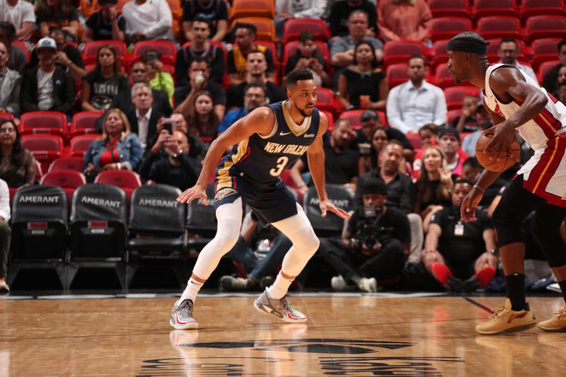 MIAMI, FL - MARCH 22: CJ McCollum #3 of the New Orleans Pelicans plays defense against Jimmy Butler #22 of the Miami Heat during the game on March 22, 2024 at Kaseya Center in Miami, Florida. NOTE TO USER: User expressly acknowledges and agrees that, by downloading and or using this Photograph, user is consenting to the terms and conditions of the Getty Images License Agreement. Mandatory Copyright Notice: Copyright 2024 NBAE (Photo by Issac Baldizon/NBAE via Getty Images)