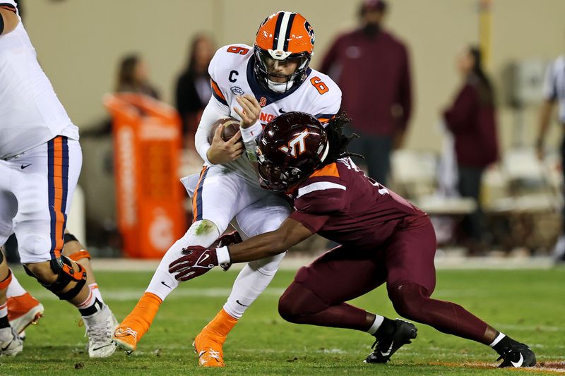 Oct 26, 2023; Blacksburg, Virginia, USA; Virginia Tech Hokies safety Keonta Jenkins (7) tackles Syracuse Orange quarterback Garrett Shrader (6) during the second quarter at Lane Stadium. Mandatory Credit: Peter Casey-USA TODAY Sports