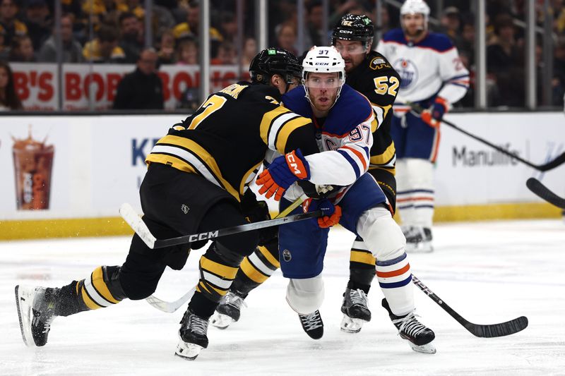 Dec 18, 2025; Boston, Massachusetts, USA; Edmonton Oilers center Connor McDavid (97) tries to get around Boston Bruins defenseman Hampus Lindholm (27) during the second period at TD Garden. Mandatory Credit: Winslow Townson-Imagn Images