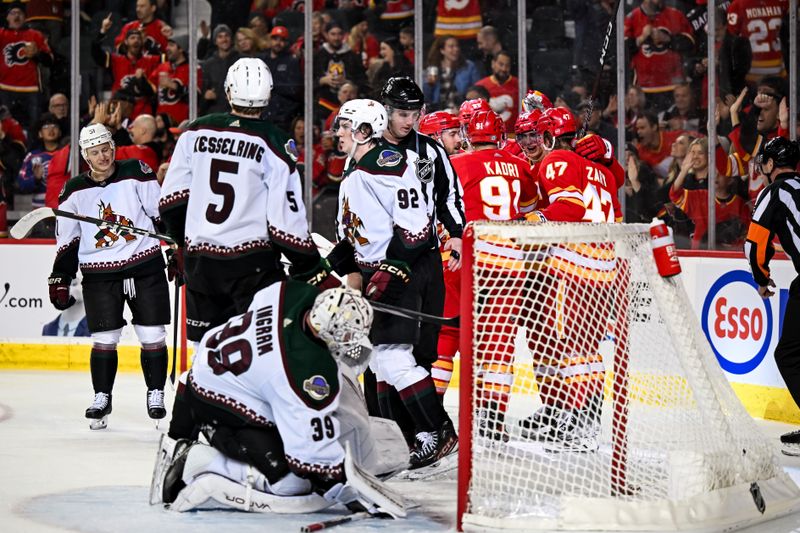 Jan 16, 2024; Calgary, Alberta, CAN; Calgary Flames center Nazem Kadri (91) and teammates celebrate after scoring a goal against Arizona Coyotes goaltender Connor Ingram (39) during the third period at Scotiabank Saddledome. Mandatory Credit: Brett Holmes-USA TODAY Sports