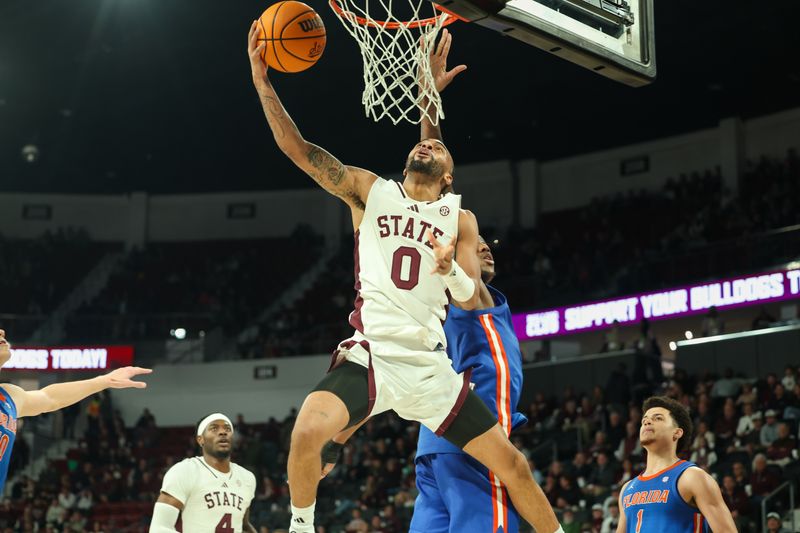 Feb 11, 2025; Starkville, Mississippi, USA; Mississippi State Bulldogs guard Claudell Harris Jr. (0) shoots as Florida Gators center Rueben Chinyelu (9) defends during the second half at Humphrey Coliseum. Mandatory Credit: Wesley Hale-Imagn Images