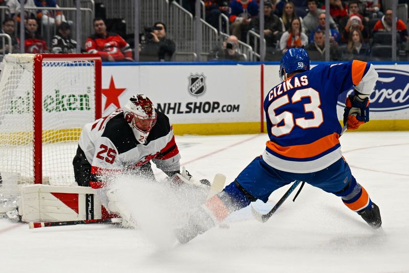 Dec 23, 2025; Elmont, New York, USA;  New Jersey Devils goaltender Jacob Markstrom (25) makes a save on New York Islanders center Casey Cizikas (53) during the second period at UBS Arena. Mandatory Credit: Dennis Schneidler-Imagn Images