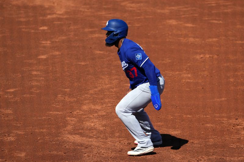 Feb 24, 2025; Goodyear, Arizona, USA; Los Angeles Dodgers outfielder Teoscar Hernández (37) leads off first base against the Cincinnati Reds during the third inning at Goodyear Ballpark. Mandatory Credit: Joe Camporeale-Imagn Images