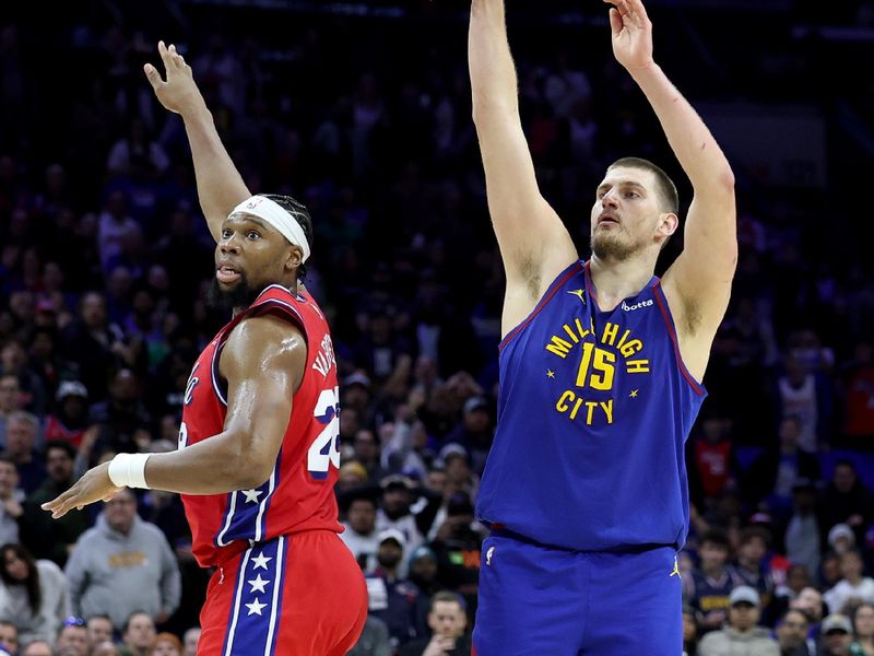 PHILADELPHIA, PENNSYLVANIA - JANUARY 31: Nikola Jokic #15 of the Denver Nuggets shoots a three-pointer against Guerschon Yabusele #28 of the Philadelphia 76ers during the second half at the Wells Fargo Center on January 31, 2025 in Philadelphia, Pennsylvania. NOTE TO USER: User expressly acknowledges and agrees that, by downloading and or using this photograph, User is consenting to the terms and conditions of the Getty Images License Agreement. (Photo by Emilee Chinn/Getty Images)