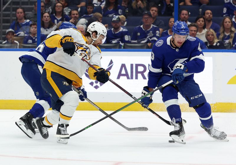 Oct 10, 2023; Tampa, Florida, USA; Tampa Bay Lightning defenseman Darren Raddysh (43) defends Nashville Predators center Tommy Novak (82) during the second period at Amalie Arena. Mandatory Credit: Kim Klement Neitzel-USA TODAY Sports