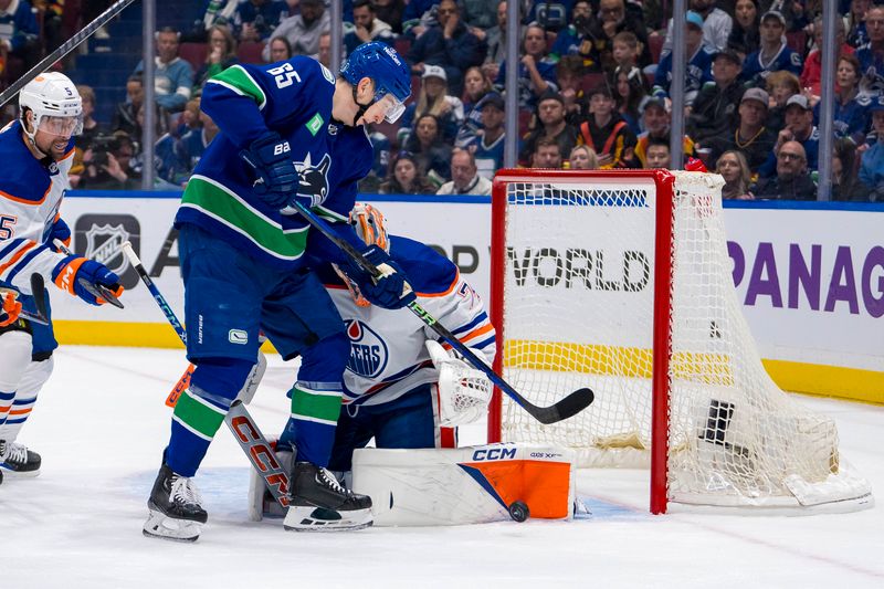 May 8, 2024; Vancouver, British Columbia, CAN; Edmonton Oilers goalie Stuart Skinner (74) blocks Vancouver Canucks forward Ilya Mikheyev (65) during the first period in game one of the second round of the 2024 Stanley Cup Playoffs at Rogers Arena. Mandatory Credit: Bob Frid-USA TODAY Sports