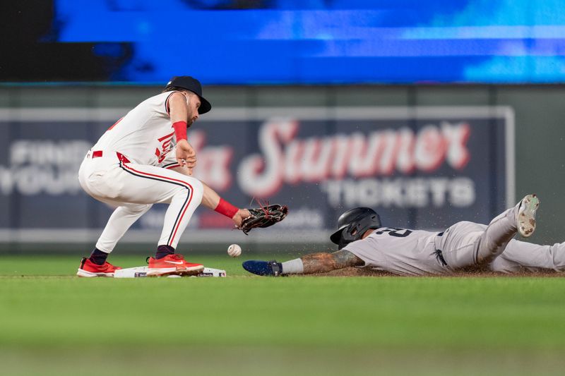 May 15, 2024; Minneapolis, Minnesota, USA; New York Yankees second base Gleyber Torres (25) steals after Minnesota Twins second base Edouard Julien (47) bobbled the throw in the eighth inning at Target Field. Mandatory Credit: Matt Blewett-USA TODAY Sports