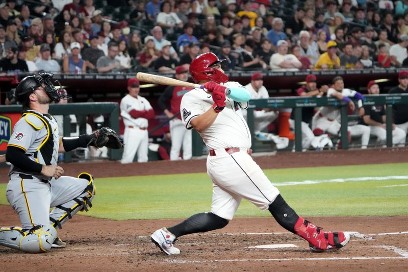 May 26, 2025; Phoenix, Arizona, USA; Arizona Diamondbacks first base Josh Naylor (22) hits a home run against the Pittsburgh Pirates during the fifth inning at Chase Field. Mandatory Credit: Joe Camporeale-Imagn Images