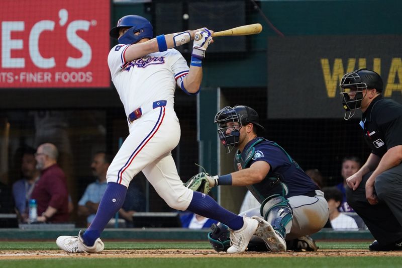 May 3, 2025; Arlington, Texas, USA; Texas Rangers third baseman Josh Jung (6) hits a single during the third inning against the Seattle Mariners at Globe Life Field. Mandatory Credit: Raymond Carlin III-Imagn Images
