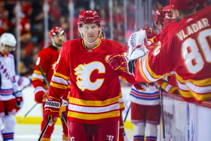 Oct 24, 2023; Calgary, Alberta, CAN; Calgary Flames center Blake Coleman (20) celebrates his goal with teammates against the New York Rangers during the first period at Scotiabank Saddledome. Mandatory Credit: Sergei Belski-USA TODAY Sports