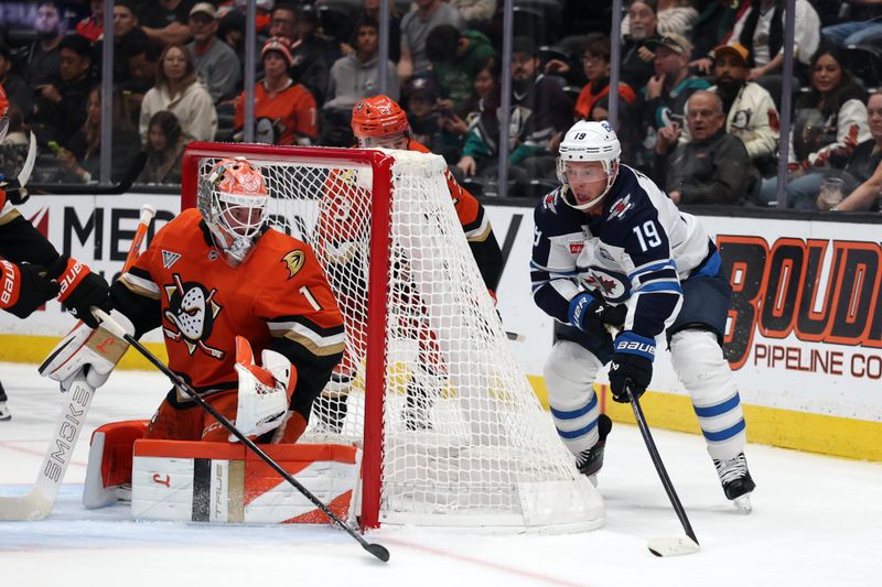 Nov 9, 2025; Anaheim, California, USA;  Winnipeg Jets center Jonathan Toews (19) controls the puck against Anaheim Ducks goaltender Lukas Dostal (1) during the first period at Honda Center. Mandatory Credit: Kiyoshi Mio-Imagn Images