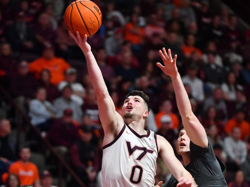 Jan 27, 2024; Blacksburg, Virginia, USA; Virginia Tech Hokies guard Hunter Cattoor (0) shoots while being defended by Georgia Tech Yellow Jackets guard Carter Murphy (4) during the second half at Cassell Coliseum. Mandatory Credit: Brian Bishop-USA TODAY Sports