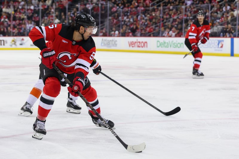 Jan 18, 2025; Newark, New Jersey, USA; New Jersey Devils defenseman Brenden Dillon (5) skates with the puck against the Philadelphia Flyers during the third period at Prudential Center. Mandatory Credit: Ed Mulholland-Imagn Images