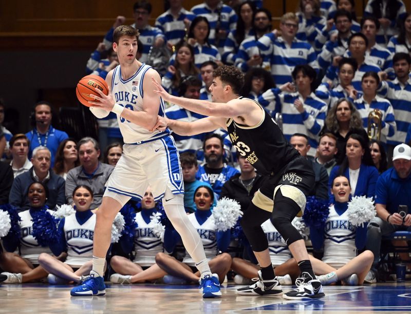 Feb 12, 2024; Durham, North Carolina, USA;  Duke Blue Devils center Kyle Filipowski (30) controls the ball in front of Wake Forest Deamon Deacons center Matthew Marsh (33)during the first half at Cameron Indoor Stadium. Mandatory Credit: Rob Kinnan-USA TODAY Sports