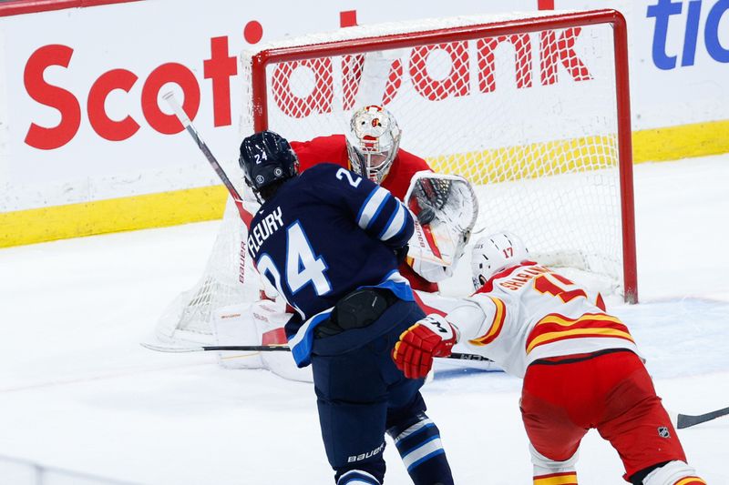 Jan 26, 2025; Winnipeg, Manitoba, CAN;  Calgary Flames goalie Dan Vladar (80) makes a save on a shot by Winnipeg Jets defenseman Hayden Fleury (24) during the third period at Canada Life Centre. Mandatory Credit: Terrence Lee-Imagn Images