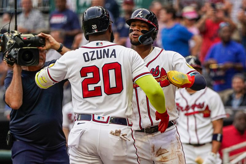 Aug 15, 2023; Cumberland, Georgia, USA; Atlanta Braves designated hitter Marcell Ozuna (20) reacts with right fielder Ronald Acuna Jr. (13) after hitting a two run home run against the New York Yankees during the first inning at Truist Park. Mandatory Credit: Dale Zanine-USA TODAY Sports