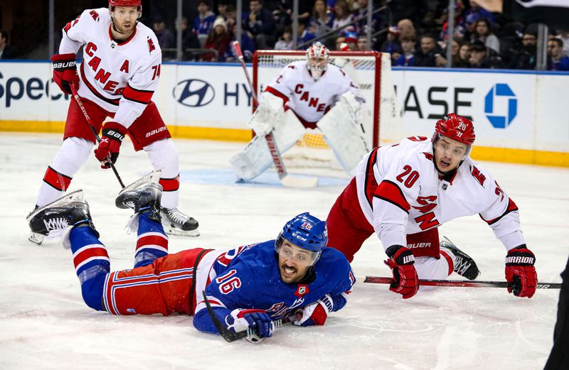 Jan 2, 2024; New York, New York, USA; New York Rangers center Vincent Trocheck (16) and Carolina Hurricanes left wing Sebastian Aho (20) fall down after a face-off during the first period at Madison Square Garden. Mandatory Credit: Danny Wild-USA TODAY Sports