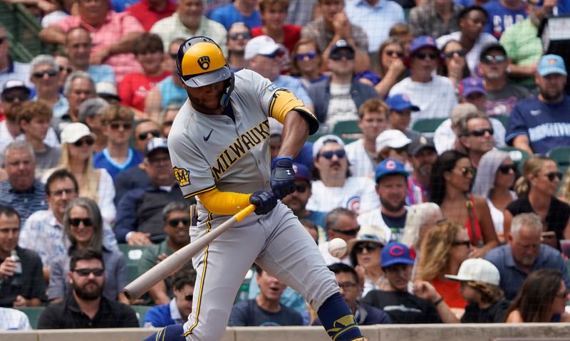 Jul 24, 2024; Chicago, Illinois, USA; Milwaukee Brewers outfielder Jackson Chourio (11) hits a single against the Chicago Cubs during the first inning at Wrigley Field. Mandatory Credit: David Banks-USA TODAY Sports