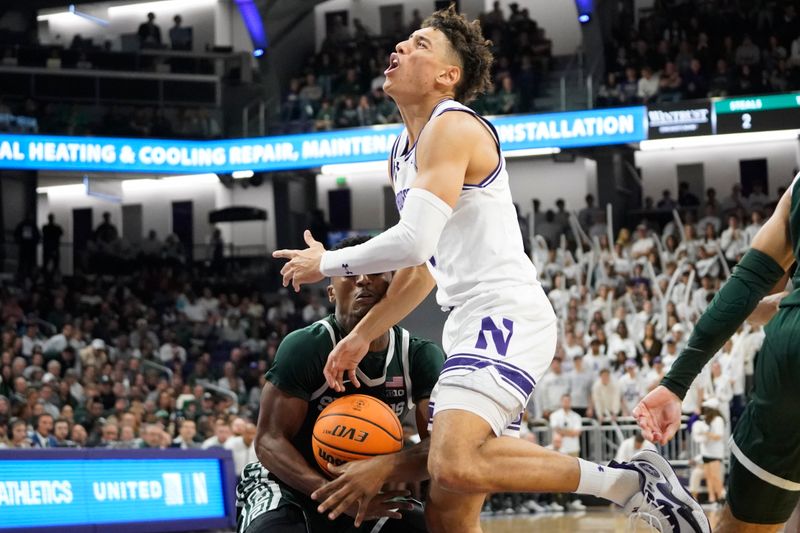 Jan 7, 2024; Evanston, Illinois, USA; Michigan State Spartans guard Tyson Walker (2) fouls Northwestern Wildcats guard Ty Berry (3) during the second half at Welsh-Ryan Arena. Mandatory Credit: David Banks-USA TODAY Sports