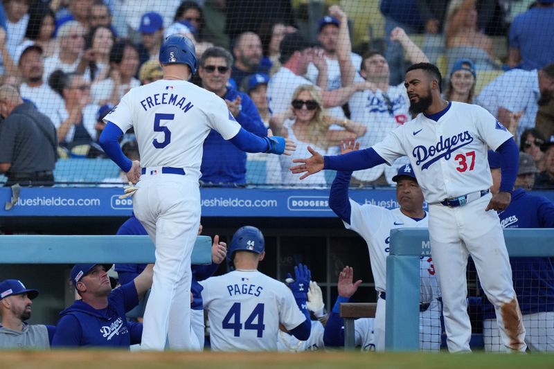Jun 15, 2024; Los Angeles, California, USA; Los Angeles Dodgers first baseman Freddie Freeman (5) is congratulated by left fielder Teoscar Hernandez (37) after scoring in the fourth inning against the Kansas City Royals at Dodger Stadium. Mandatory Credit: Kirby Lee-USA TODAY Sports