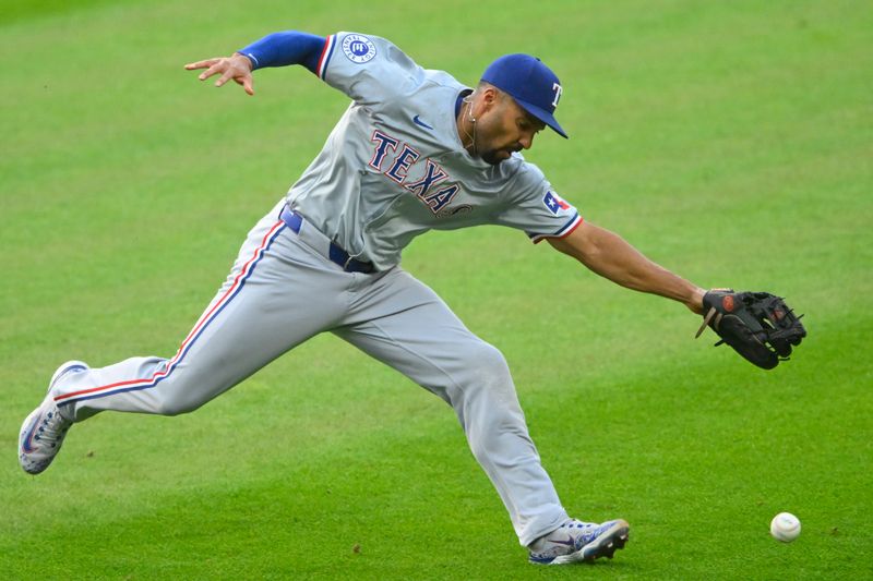 Aug 24, 2024; Cleveland, Ohio, USA; Texas Rangers second baseman Marcus Semien (2) reaches for the ball in the first inning against the Cleveland Guardians at Progressive Field. Mandatory Credit: David Richard-USA TODAY Sports