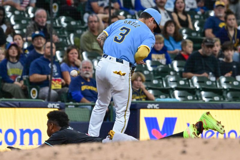 Sep 22, 2024; Milwaukee, Wisconsin, USA; Arizona Diamondbacks shortstop Geraldo Perdomo (2) slides into third base with a triple and scored when ball got past Milwaukee Brewers third baseman Joseph Ortiz (3) in the third inning at American Family Field. Mandatory Credit: Benny Sieu-Imagn Images