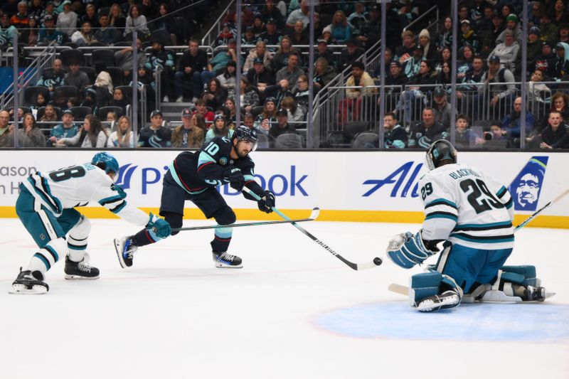 Nov 30, 2024; Seattle, Washington, USA; Seattle Kraken center Matty Beniers (10) shoots a goal shot against San Jose Sharks goaltender Mackenzie Blackwood (29) during the second period at Climate Pledge Arena. Mandatory Credit: Steven Bisig-Imagn Images