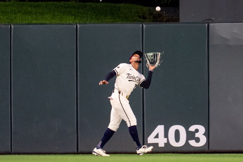 Sep 26, 2024; Minneapolis, Minnesota, USA; Miami Marlins third base Jake Burger (36) flies out to Minnesota Twins outfielder Byron Buxton (25) in the seventh inning at Target Field. Mandatory Credit: Matt Blewett-Imagn Images